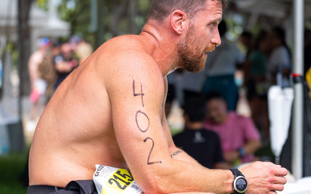 Kyle Ruth seated between events at the CrossFit Games, checking his watch