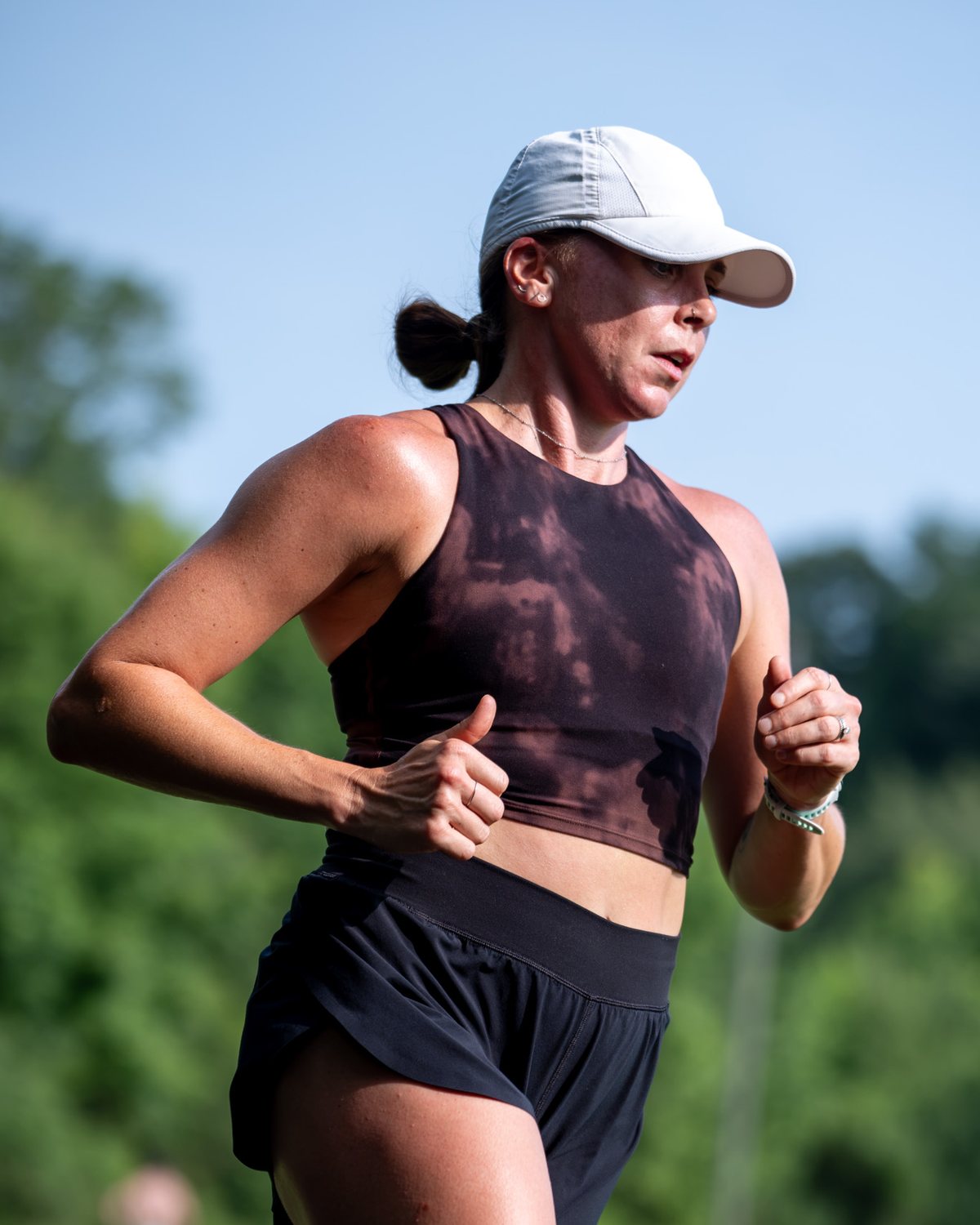 Haley Ruth running outdoors in a white cap
