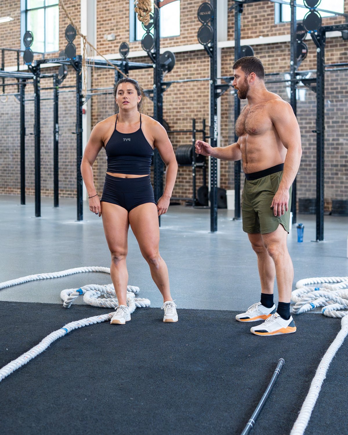 Kyle Ruth giving coaching cues to an athlete between sets